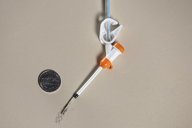Close up of a small sensor next to a dime for scale in a lab at Georgia Tech.